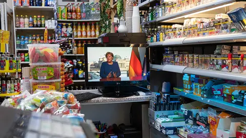 Una televisión muestra uno de los discursos de Ángela Merkel durante la crisis del coronavirus. Christophe Gateau/dpa
