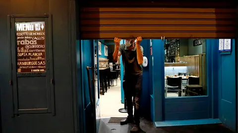 Los establecimientos de hostelería de Navarra han bajado este miércoles la persiana a las 22:00 horas en cumplimiento de la normativa en vigor hasta esta medianoche, momento en el que una nueva Orden Foral les obliga a un cierre total durante 14 días, una medida que rechazan y que les ha llevado a movilizarse. EFE/Jesús Diges