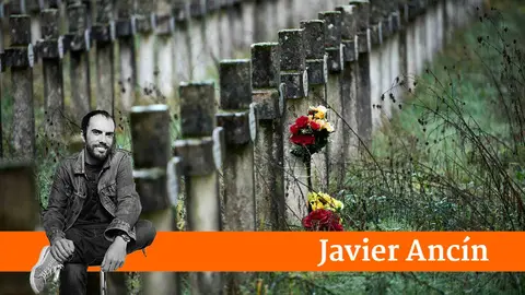 Varias personas llevan flores a sus sere queridos durante la celebraci&oacute;n de Todos los Santos en el cementerio de Pamplona. PABLO LASAOSA