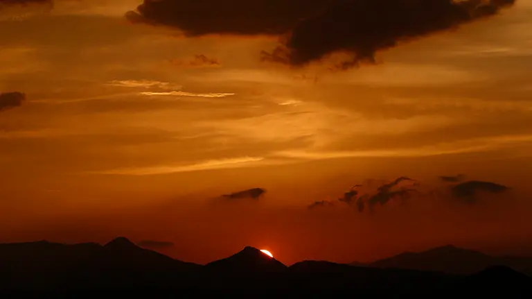 El sol se pone esta tarde en Pamplona en una jornada con un tiempo marcado por las altas temperaturas, cerca de los 25 grados, junto con las tormentas que han dejado ligeras lluvias. EFE/Jes&uacute;s Diges