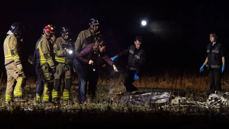 Bomberos y agentes de la Guardia Civil inspeccionan el lugar donde dos hombres de 54 y 47 a&ntilde;os, han fallecido este jueves al estrellarse la avioneta biplaza con la que despegaban. EFE/Marcial Guill&eacute;n