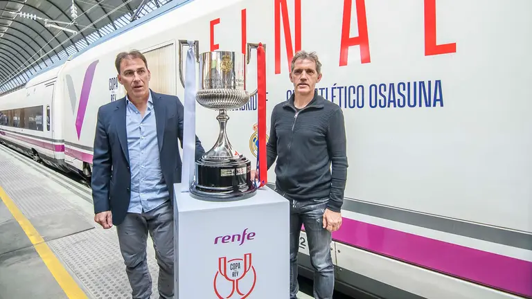 Los exjugadores de fútbol Rafa Martín Vázquez (i), por el Real Madrid y Jon Andoni Goikoetxea (2i), por el C.A. Osasuna, los dos equipos que este sábado próximo disputarán la final de la Copa del Rey, trofeo con el que posan tras bajar del AVE a su llegada este jueves a Sevilla donde se jugará en el estadio de La Cartuja. EFE/ Raúl Caro.