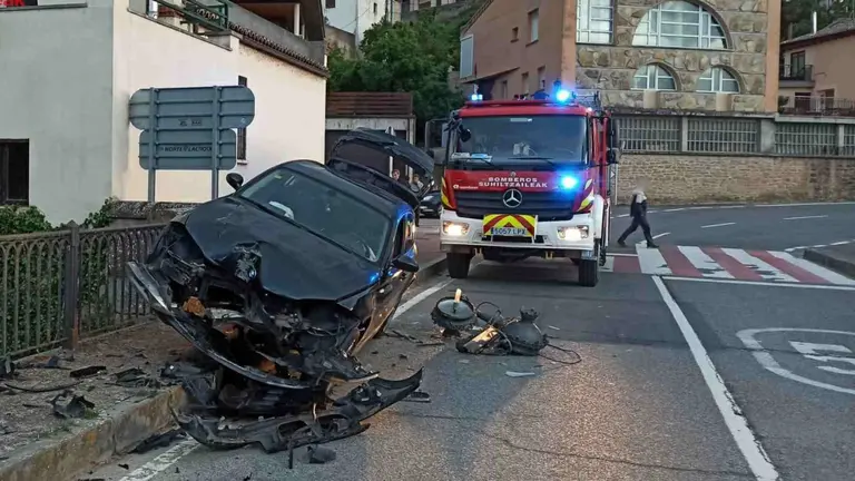 El coche qued&oacute; encajado en el puente sobre la base de la farola que acaba de arrancar de cuajo. BOMBEROS DE NAVARRA