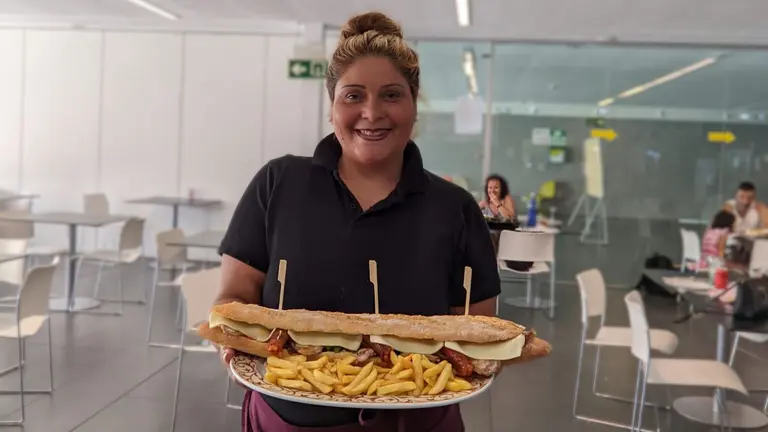 Una de las trabajadoras del bar de las piscinas de Aranzadi y San Jorge con el bocadillo Juanito-Juan XXL. CEDIDA