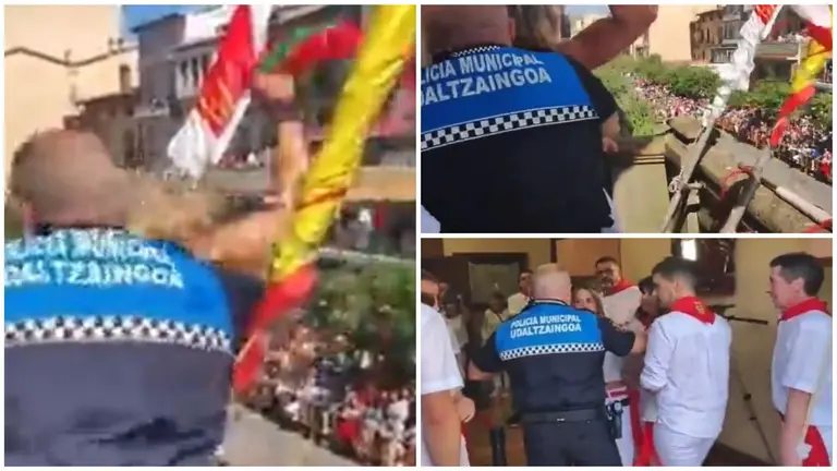 Momento en el que la Polic&iacute;a Municipal de Estella retira del balc&oacute;n a la concejal de EH Bildu que ha pretendido exhibir una bandera de la Comunidad Aut&oacute;noma Vasca (ikurri&ntilde;a) durante el cohete de Estella.