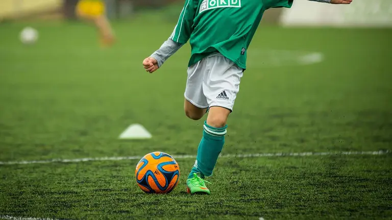 Un chico juega a f&uacute;tbol en un campo de hierba. ARCHIVO