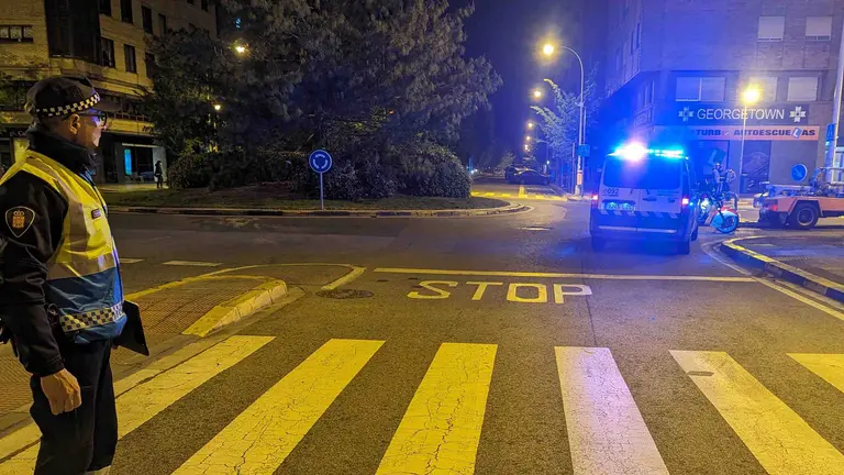 Un agente regula el tr&aacute;fico mientras atienden al conductor del ciclomotor. POLIC&Iacute;A MUNICIPAL DE PAMPLONA