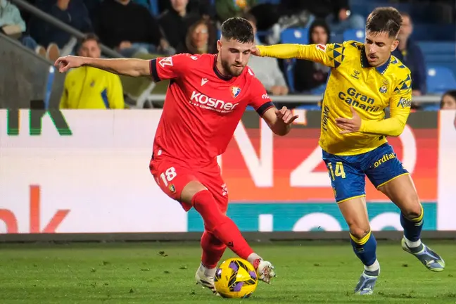 El centrocampista de Osasuna Iker Muñoz (i) lucha con Manuel Fuster, de Las Palmas, durante el partido de LaLiga entre la UD Las Palmas y el Osasuna, este viernes en el estadio de Gran Canaria. EFE/ Angel Medina G.
