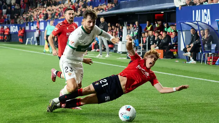 Victor Chust (23. Elche CF) y Víctor Muñoz (21. CA Osasuna) durante el partido de La Liga EA Sports entre CA Osasuna y Elche CF disputado en el estadio de El Sadar en Pamplona. IÑIGO ALZUGARAY