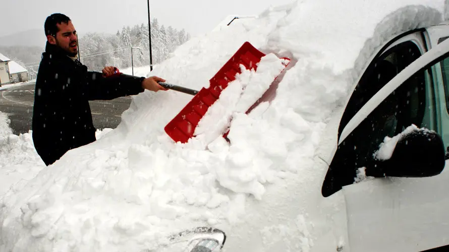 Un peregrino de Barcelona que realiza el Camino de Santiago retira la nieve acumulada en un vehículo en Roncesvalles (Navarra), localidad que hoy ha amanecido nevada debido a la progresiva bajada de la cota de nieve, que ha hecho que durante la noche se movilicen máquinas quitanieves de forma preventiva. EFE/Villar López