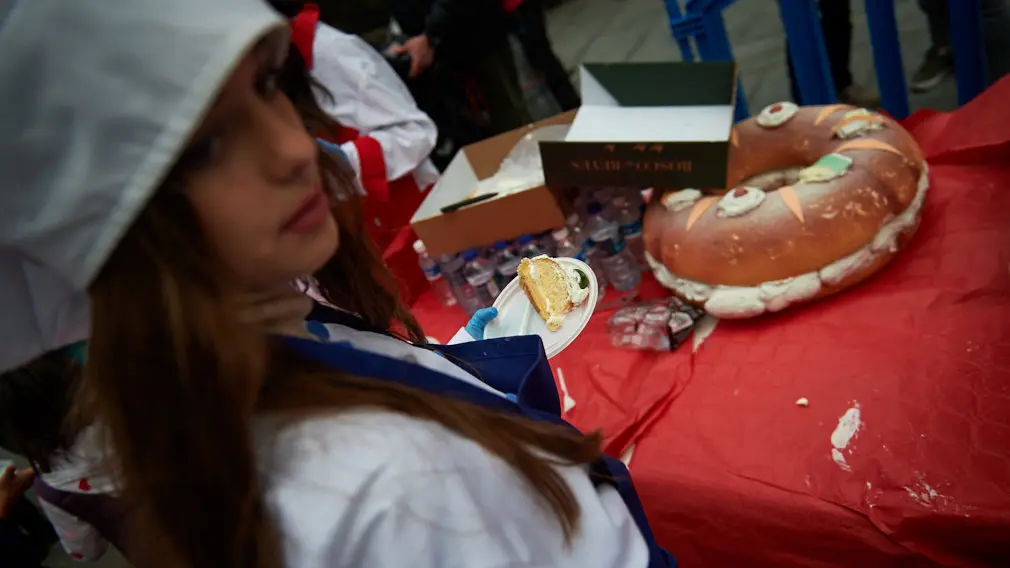 Degustación de los roscones de Reyes en la calle Bergamín con la presencia de las monturas reales. MIGUEL OSÉS