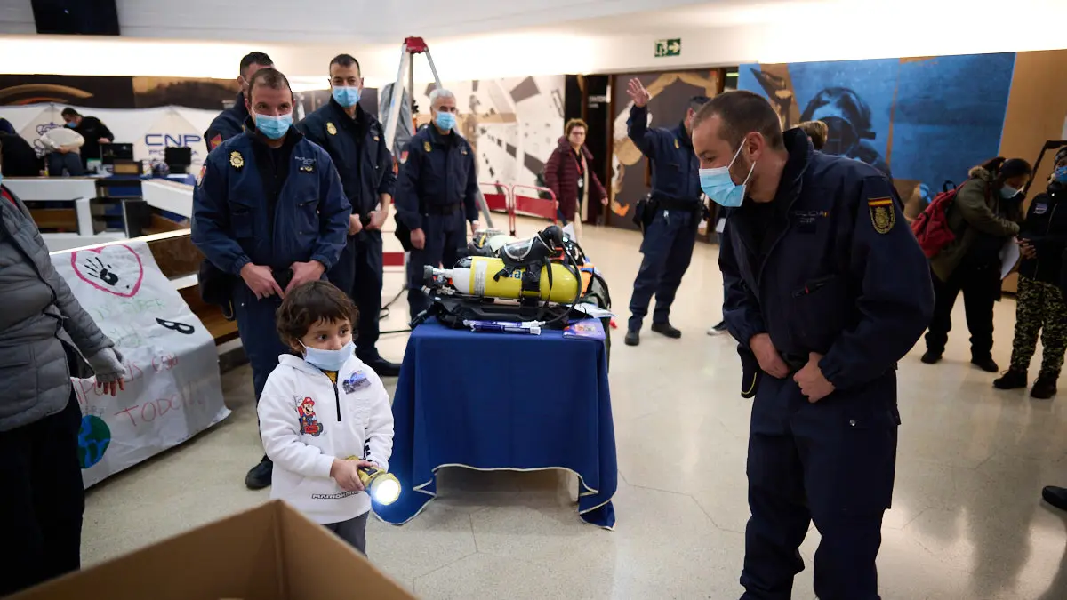 La Policía Nacional entrega manualidades que han realizado escolares para personas enfermas dentro de la iniciativa solidaria 'En tus manos una sonrisa'. PABLO LASAOSA