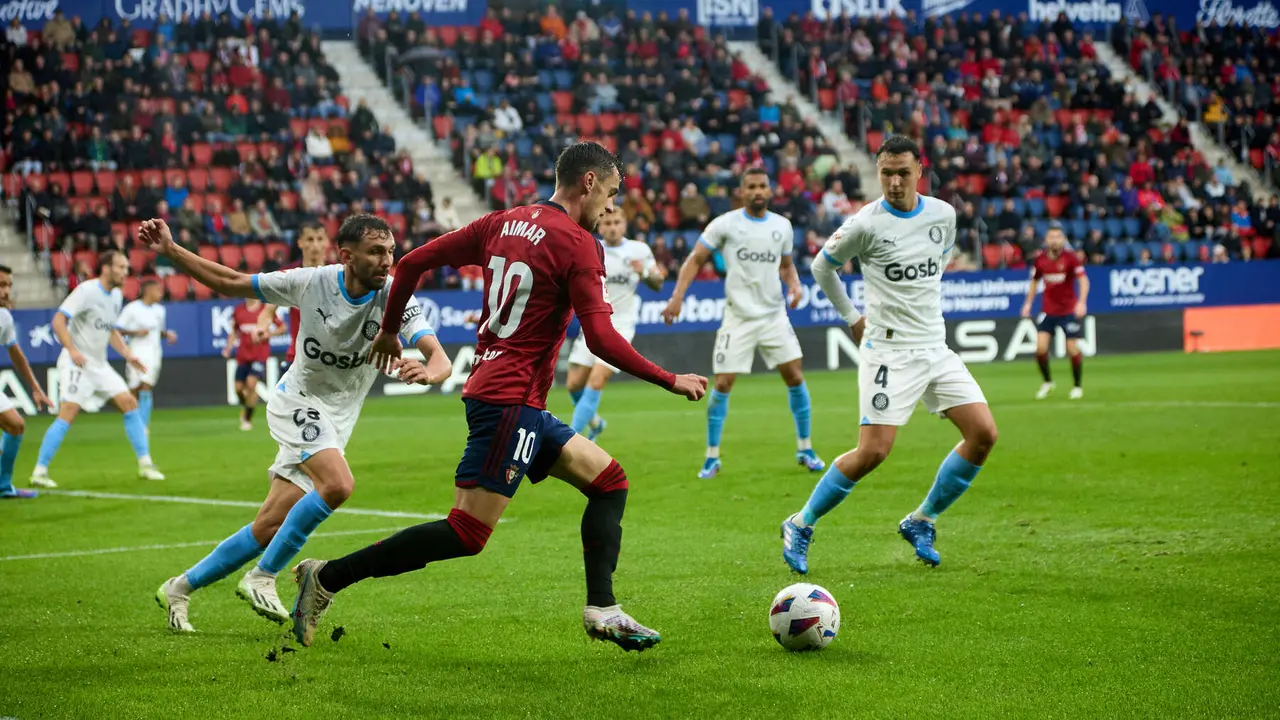 Aimar Oroz (10. CA Osasuna) y Iván Martín (23. Girona FC) durante el partido de La Liga EA Sports entre CA Osasuna y Girona FC disputado en el estadio de El Sadar en Pamplona. IÑIGO ALZUGARAY