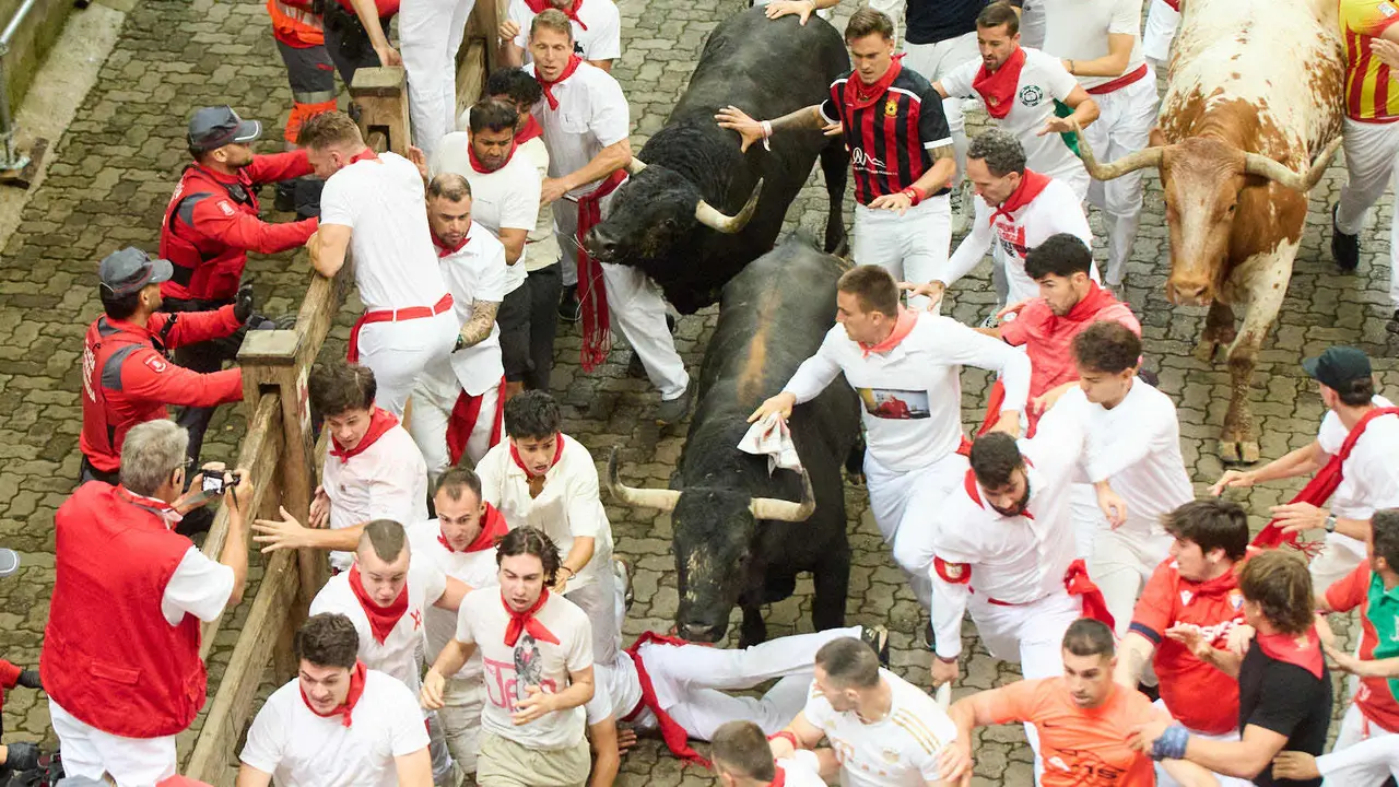 Primer encierro de San Fermín 2025 con toros de Fuente Ymbro en el tramo de Telefónica y el callejón de entrada a la plaza. IÑIGO ALZUGARAY