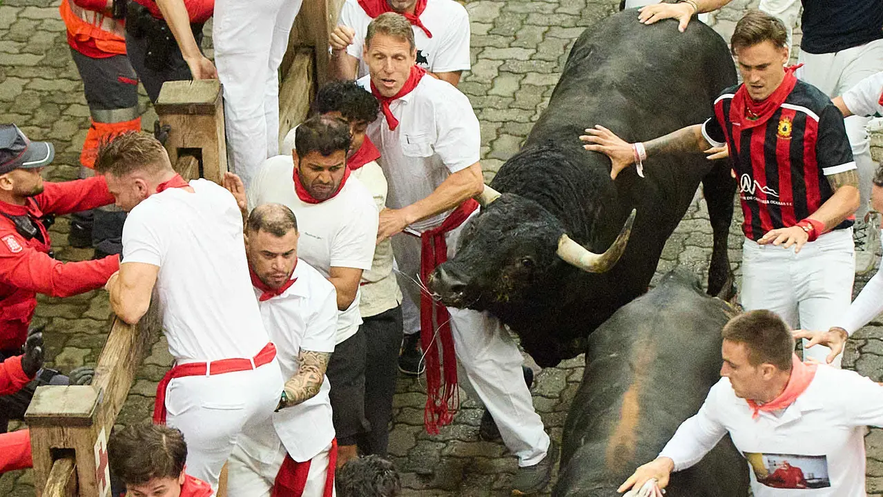 Primer encierro de San Fermín 2025 con toros de Fuente Ymbro en el tramo de Telefónica y el callejón de entrada a la plaza. IÑIGO ALZUGARAY