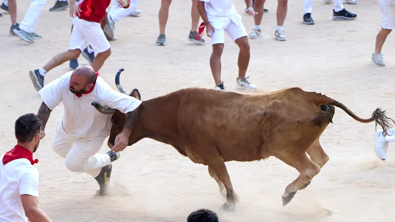 Quinto encierro de San Fermín 2025 con toros de la ganadería de Jandilla en el tramo del callejón y la entrada a la Plaza de Toros. IÑIGO ALZUGARAY