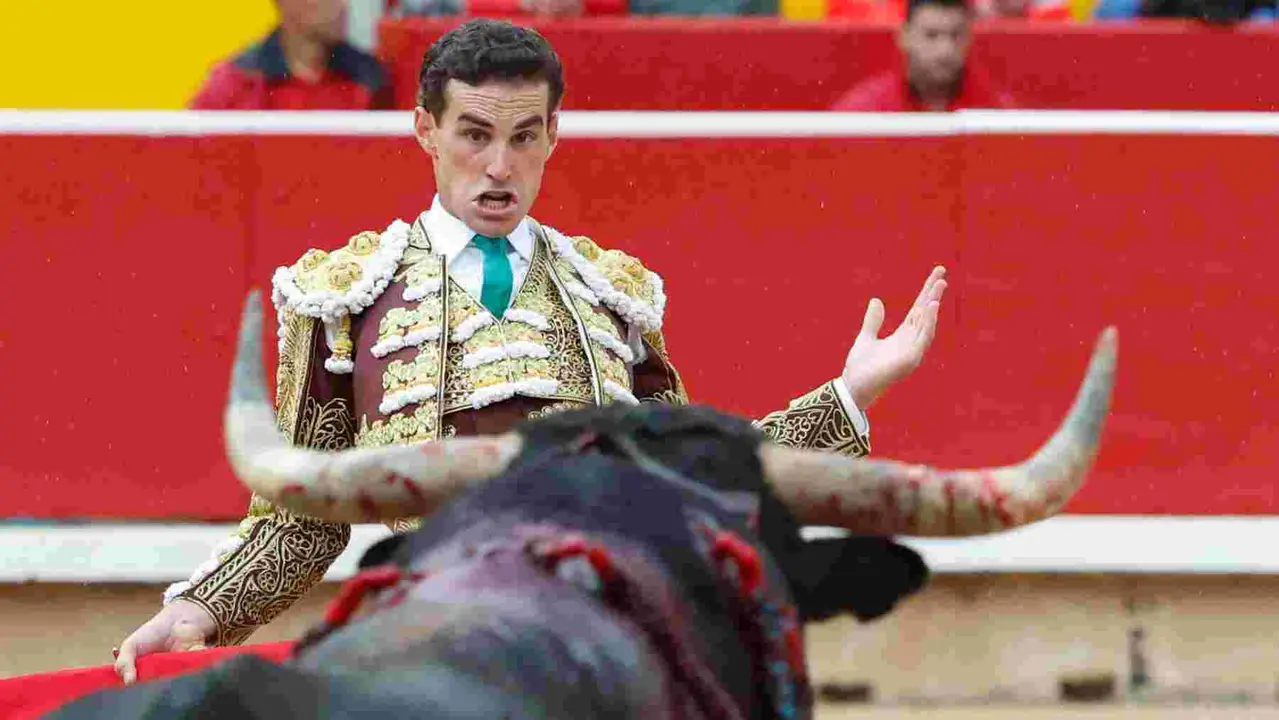 El torero Fernando Adrián durante la lidia a su primer toro de la tarde en la novena de abono de la Feria de Toro de los Sanfermines 2025 con toros de la ganadería gaditana La Palmosilla y en la que comparte cartel con los diestros Jiménez Fortes y Ginés Marín. EFE/Jesús Diges