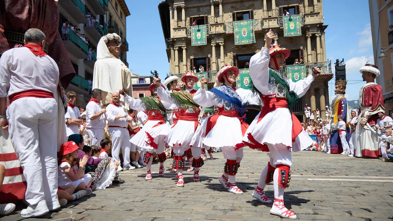 La Comparsa de Gigantes y Cabezudos acompañada del grupo de danzas Duguna Iruñeko Dantzariak bailan en honor a la ciudad antes de su despedida en la plaza del Ayuntamiento de Pamplona en el último día de las fiestas de San Fermín 2025. IÑIGO ALZUGARAY