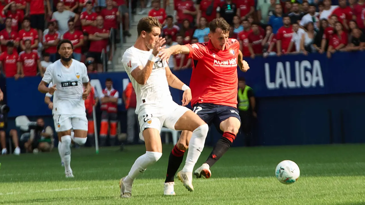 Jesús Vázquez (21. Valencia CF) y Ante Budimir (17. CA Osasuna) durante el partido de La Liga EA Sports entre CA Osasuna y Valencia CF disputado en el estadio de El Sadar en Pamplona. IÑIGO ALZUGARAY
