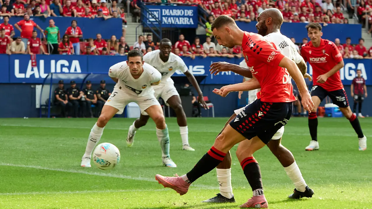 Raúl García (9. CA Osasuna) y Dimitri Foulquier (20. Valencia CF) durante el partido de La Liga EA Sports entre CA Osasuna y Valencia CF disputado en el estadio de El Sadar en Pamplona. IÑIGO ALZUGARAY