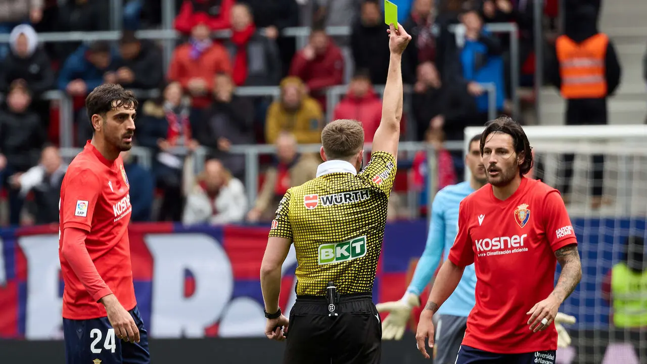 Miguel Sesma Espinosa (&aacute;rbitro del partido) muestra una tarjeta aAprilla a Juan Cruz (3. CA Osasuna) durante el partido de La Liga EA Sports entre CA Osasuna y Real Betis disputado en el estadio de El Sadar en Pamplona. I&Ntilde;IGO ALZUGARAY