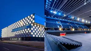 Se iluminan de noche en la calle Sadar de Pamplona los cubos de la fachada y el interior del Navarra Arena