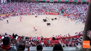 Un mozo con camiseta a rayas protagoniza un susto en la arena pamplonesa ante la rápida llegada de los astados