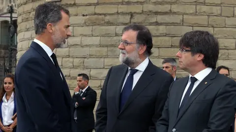 El rey Felipe conversa en Barcelona junto a Mariano Rajoy y Carles Puigdemont. EFE