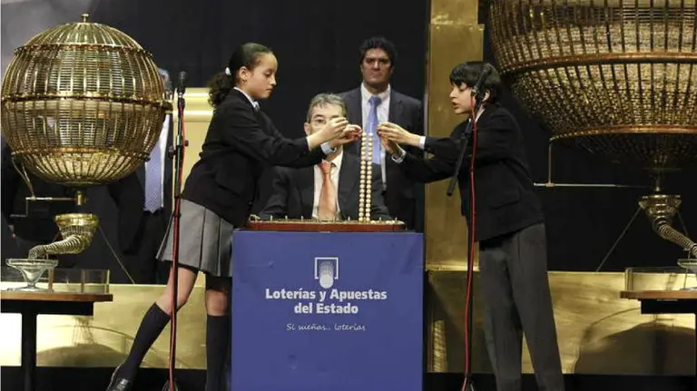 Ismael Rastrelli y Sherley Fonseca colocan en el alambre las bolas con el número del Gordo. EFE