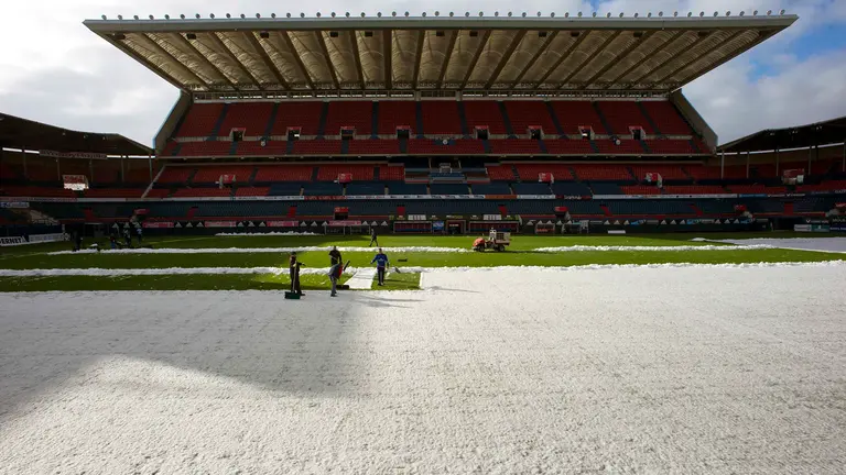 Operarios del C.A. Osasuna retiran esta mañana la nieve acumulada en el estadio de El Sadar tras las últimas precipitaciones caídas la pasada madrugada en Pamplona y que han acumulado menos espesores de lo previsto. EFE/Villar López