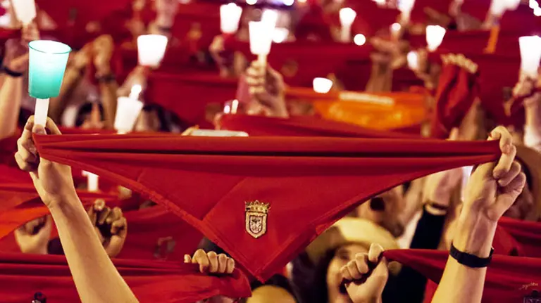 Una persona alza un pañuelico de San Fermín durante el Pobre de Mí. GARZARON (PAMPLONA.ES)
