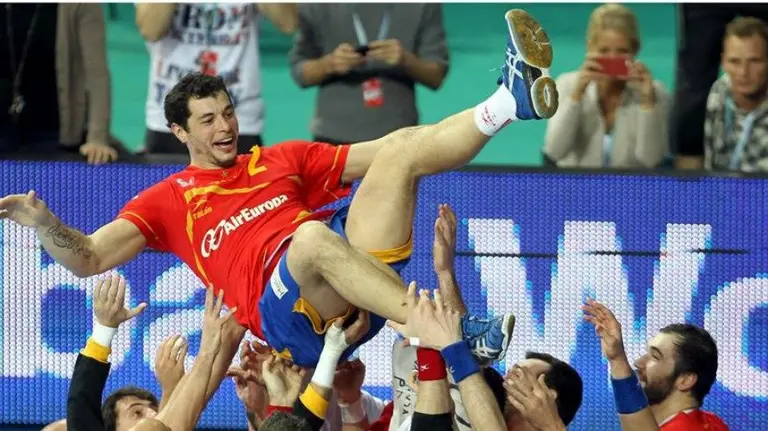 Alberto Entrerríos es levantado por sus compañeros de selección. Efe