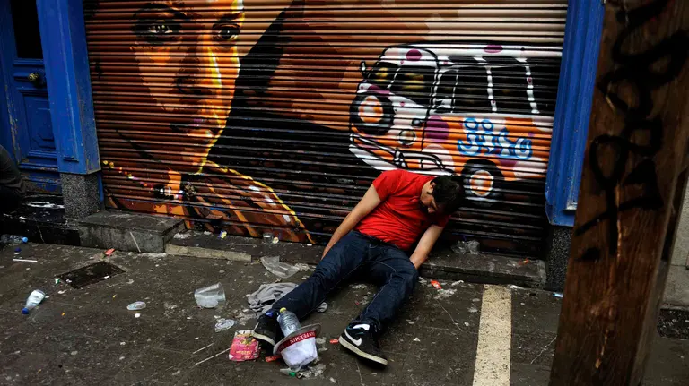 A reveller sleeps it off during the San Fermin festival in Pamplona July 12, 2014. The festival, a heady mix of drinking, dancing, late nights and bullfights, made famous by Ernest Hemingway in his novel "The Sun Also Rises", runs for nine days until July 14. REUTERS/Eloy Alonso (SPAIN - Tags: SOCIETY)CODE: X01457
