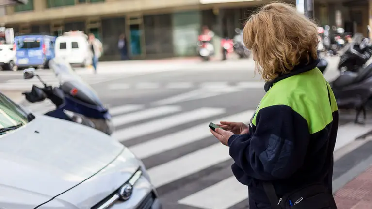 Una vigilante de la zona azul de Pamplona realiza su trabajo en el centro de Pamplona (4). IÑIGO ALZUGARAY