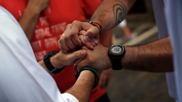 Sergio Colas (R) greets another runner after coming out unscathed from the first bull run of the San Fermin festival in Pamplona, northern Spain, July 7, 2016.