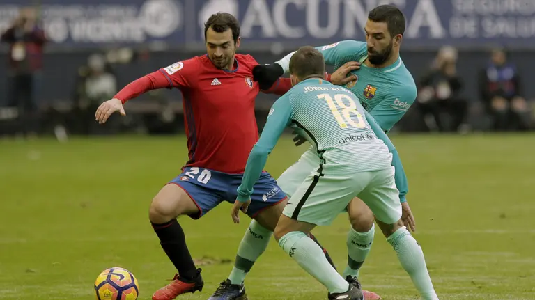 El centrocampista de Osasuna Miguel de las Cuevas controla el balón ante el defensa del FC Barcelona, Jordi Alba. EFE/Villar López