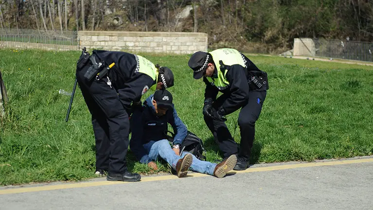 Un hombre ayudado por agentes de la Policía Municipal de Pamplona. MIGUEL OSÉS