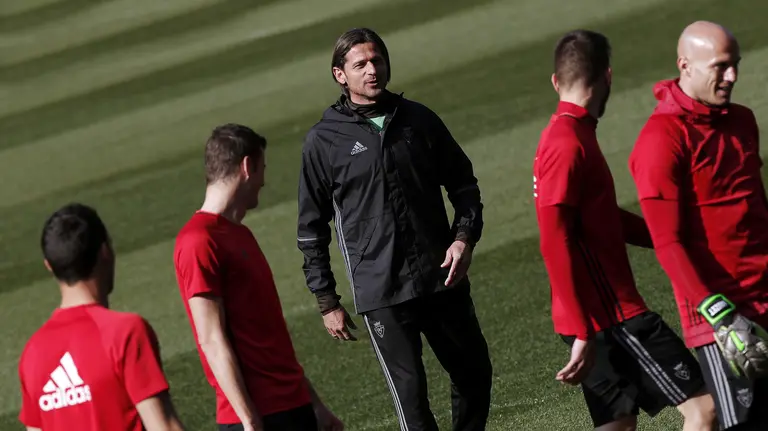 El entrenador serbio de Osasuna, Petar Vasiljevic (c), da instrucciones a sus jugadores durante el entrenamiento realizado este sábado en el estadio El Sadar, previo al partido del lunes ante el Eibar. EFE/Ivan Aguinaga