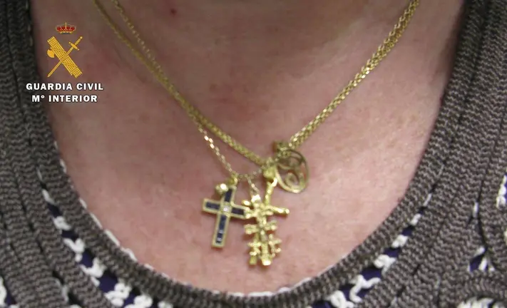 Mujer con varias cadenas y colgantes de oro. GC