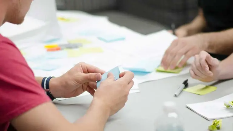 Dos personas atienden a un joven en una oficina. ARCHIVO