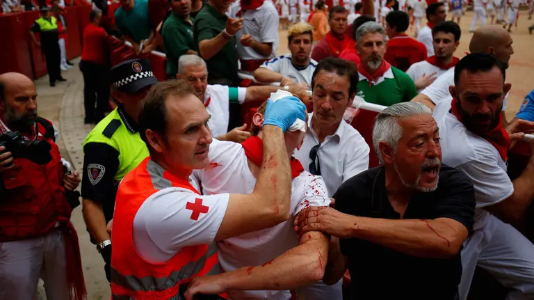 A reveller injured by a wild cow is taken away from the bullring following the seventh running of the bulls at the San Fermin festival in Pamplona, northern Spain, July 13, 2017. REUTERS/Susana VeraCODE: X01622