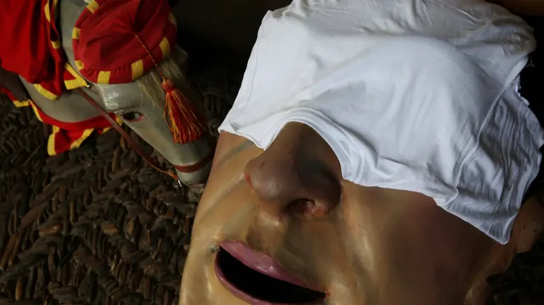 The masks for the "Comparsa de gigantes y cabezudos" (Parade of the Giants and Big Heads) lie on the floor as the men who carry them rest during the San Fermin festival in Pamplona, Spain, July 11, 2017. REUTERS/Susana VeraCODE: X01622