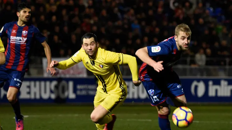 Quique en pugna con la defensa del Huesca. La Liga.