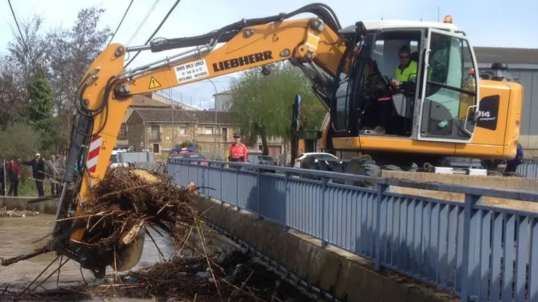 La Policía Foral colabora en los trabajos de limpieza de la maleza atrapada en el puente del río Cidacos en Pitillas tras las inundaciones. POLICÍA FORAL