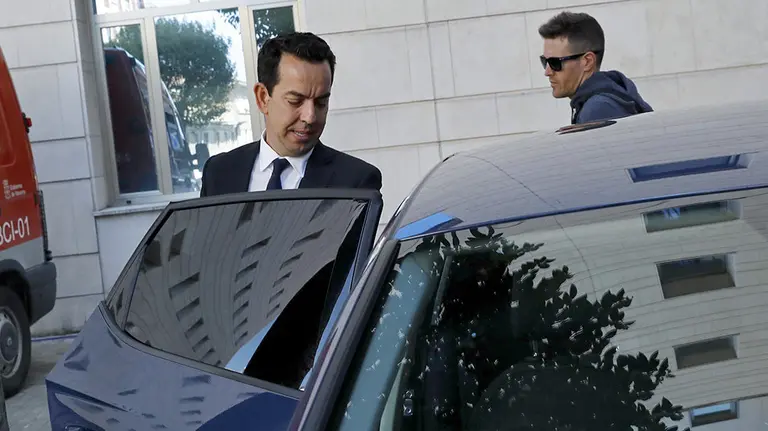 El abogado del Guardia Civil acusado de la violación en grupo de una joven de 18 años en los sanfermines del 2016, Jesús Pérez Pérez, abandona el Palacio de Justicia de Navarra protegido por agentes de la Policía Foral. EFE/Villar López