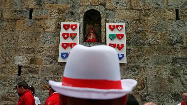 A reveller looks at the image of San Fermin, protector of runners, before the Encierro Txiki (Little Bull Run) during the San Fermin festival in Pamplona, Spain July 13, 2016. REUTERS/Susana VeraCODE: X01622