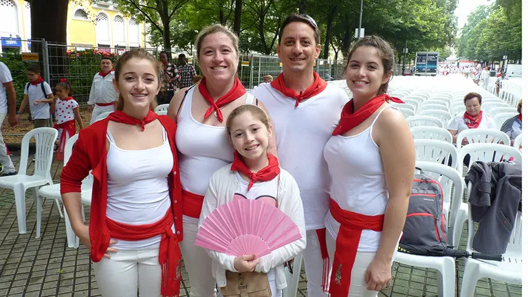 Pilar López Virgili, a la izquierda con chaqueta roja, junto a su familia en el paseo de Sarasate de Pamplona.