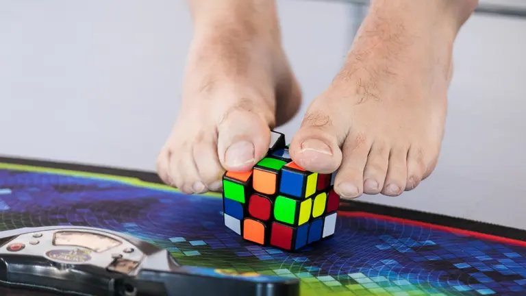 Julen Simón Iriarte, de la Asociación Española de Cubo de Rubik, monta el cubo con los pies durante la presentación del XV Campeonato de España que tendrá lugar en Pamplona. IÑIGO ALZUGARA (2)