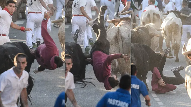 Secuencia en la que uno de los mozos es enganchado por un toro en el primer encierro de las fiestas de Tafalla PABLO LASAOSA