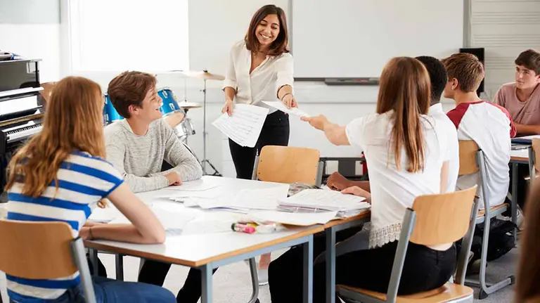 Teenage Students Studying In Music Class With Female Teacher